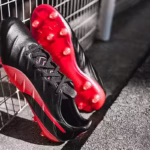 Puma King Platinum 21 FG/AG soccer cleats in black and red colorway