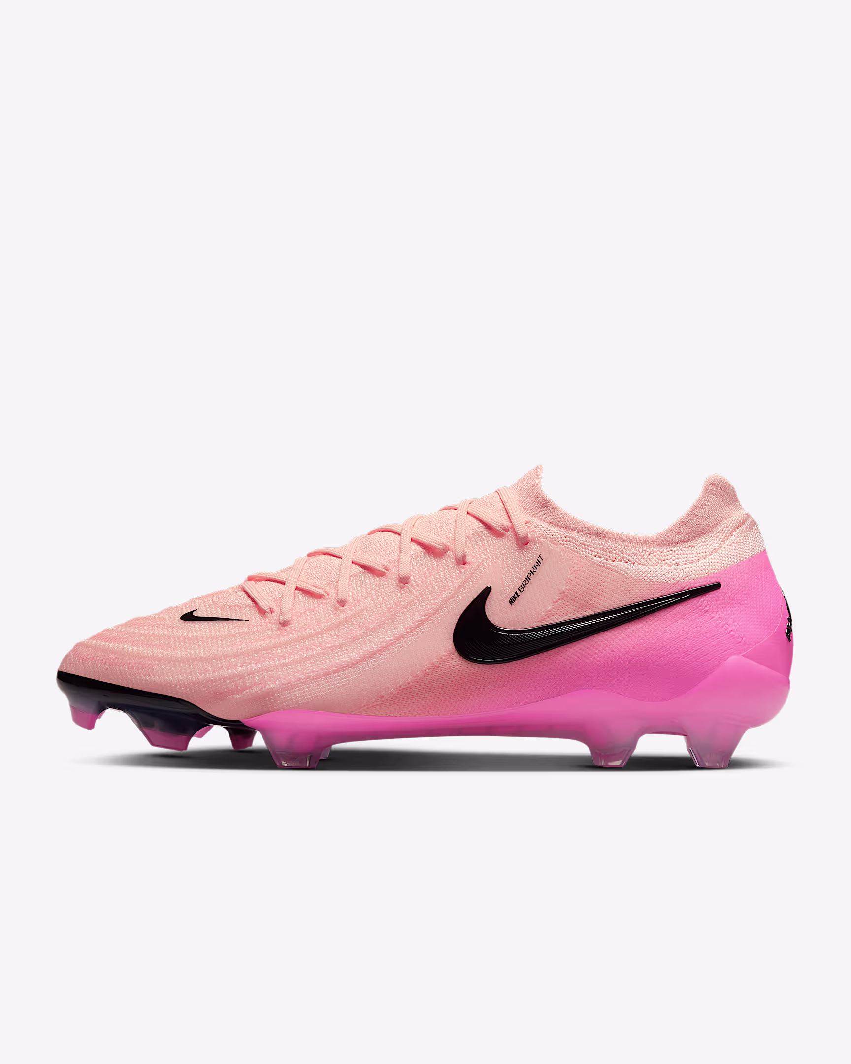 Nike Phantom GX2 Elite FG soccer cleats – light orange upper with pink heel and black swoosh, designed for firm ground play