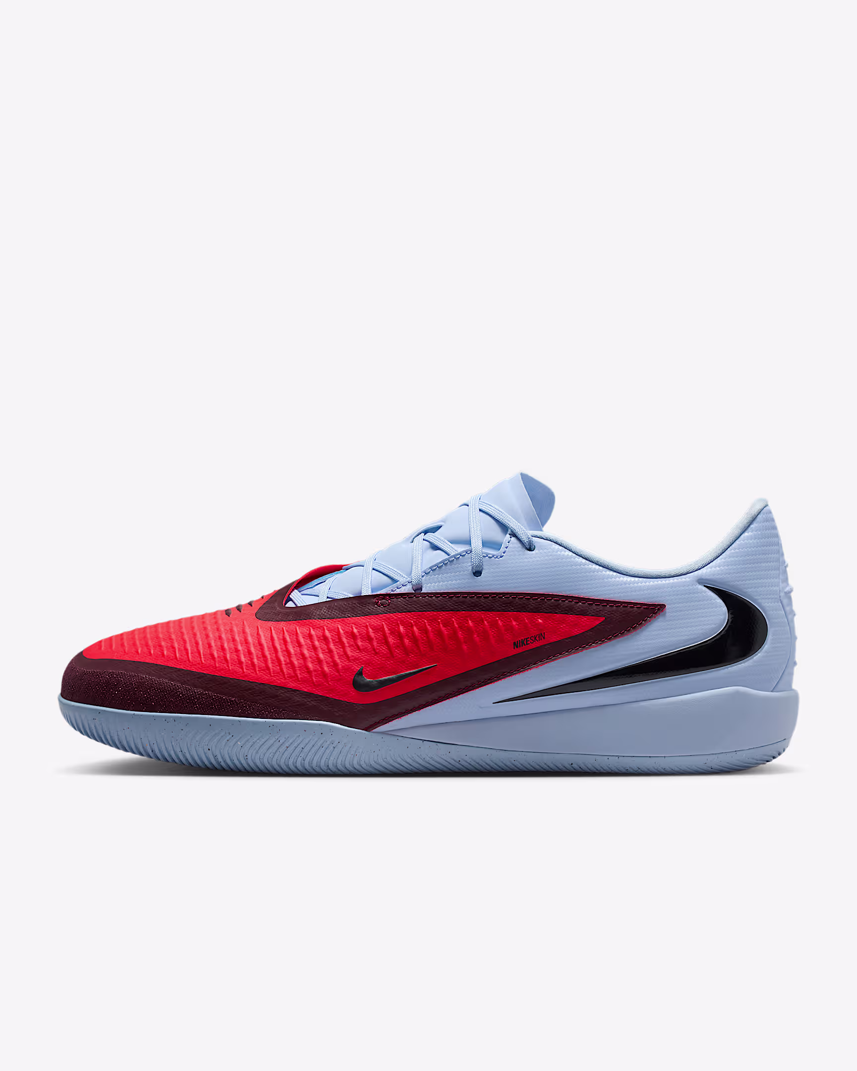 Nike Phantom  6 Low Academy IC – indoor soccer shoes with red and light blue upper, black Swoosh, and flat gum sole for court play